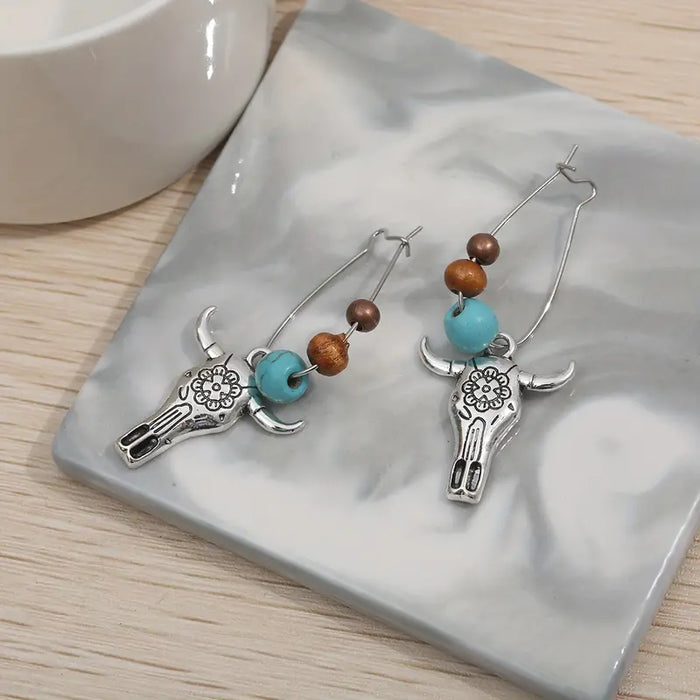 Boho Cow Head Earrings only at Bling & Bloom's Boutique | Western-Styl Earrings Bling & Bloom's Boutique Boho Cow Head Earrings Express your wild side with these fun and fashionable cow head earrings. Show off your unique style with a touch of western flair! Express you