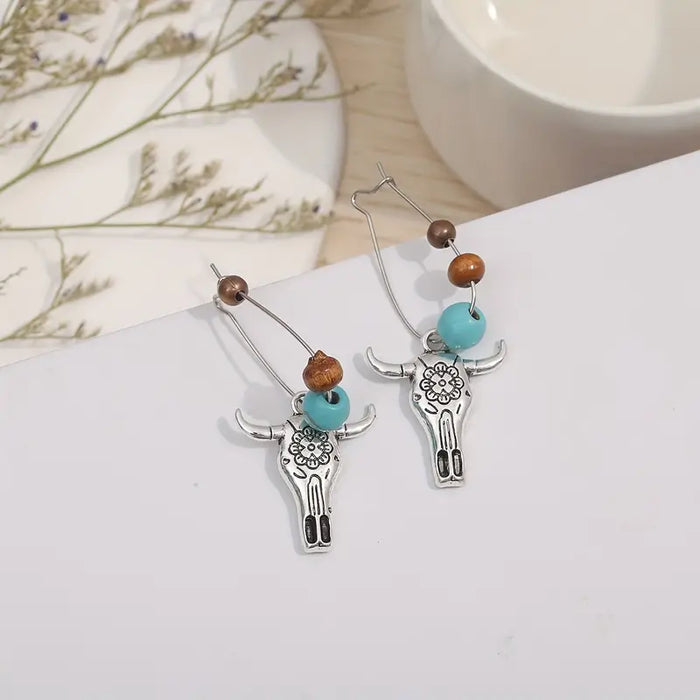 Boho Cow Head Earrings only at Bling & Bloom's Boutique | Western-Styl Earrings Bling & Bloom's Boutique Boho Cow Head Earrings Express your wild side with these fun and fashionable cow head earrings. Show off your unique style with a touch of western flair! Express you