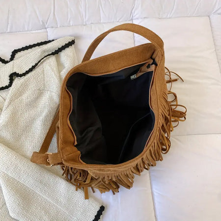 Vintage Tassel Hobo Bag only at Bling & Bloom's Boutique | Western Sty Purses, Sling Backpacks, Hobo Bags Bling & Bloom's Boutique Vintage Tassel Hobo Bag. Unlock your inner fashionista with this vintage-inspired hobo bag. Featuring a stylish tassel design, you'll be turning heads wherever you g