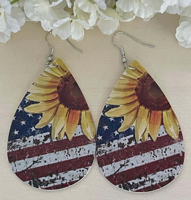 Patriotic Sunflower, Stars and Stripes Faux Leather Earrings | Holiday Earrings Bling & Bloom's Boutique American Flag faux leather earrings with Sunflowers. Great for Patriotic Holidays and every day wear too. Give them as gifts too.

