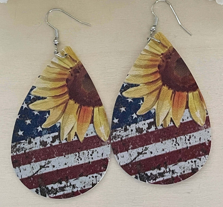 Patriotic Sunflower, Stars and Stripes Faux Leather Earrings | Holiday Earrings Bling & Bloom's Boutique American Flag faux leather earrings with Sunflowers. Great for Patriotic Holidays and every day wear too. Give them as gifts too.

