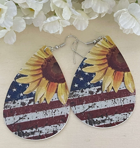 Patriotic Sunflower, Stars and Stripes Faux Leather Earrings | Holiday Earrings Bling & Bloom's Boutique American Flag faux leather earrings with Sunflowers. Great for Patriotic Holidays and every day wear too. Give them as gifts too.

